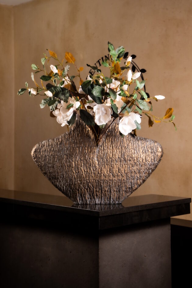 White Floral Arrangement in Sculpted Bronze Vase